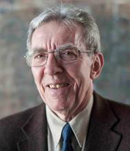 A person wearing glasses and a suit

Description automatically generated with medium confidence